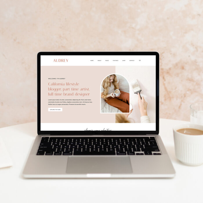 Image of a laptop with the Audrey WordPress theme displayed on the screen