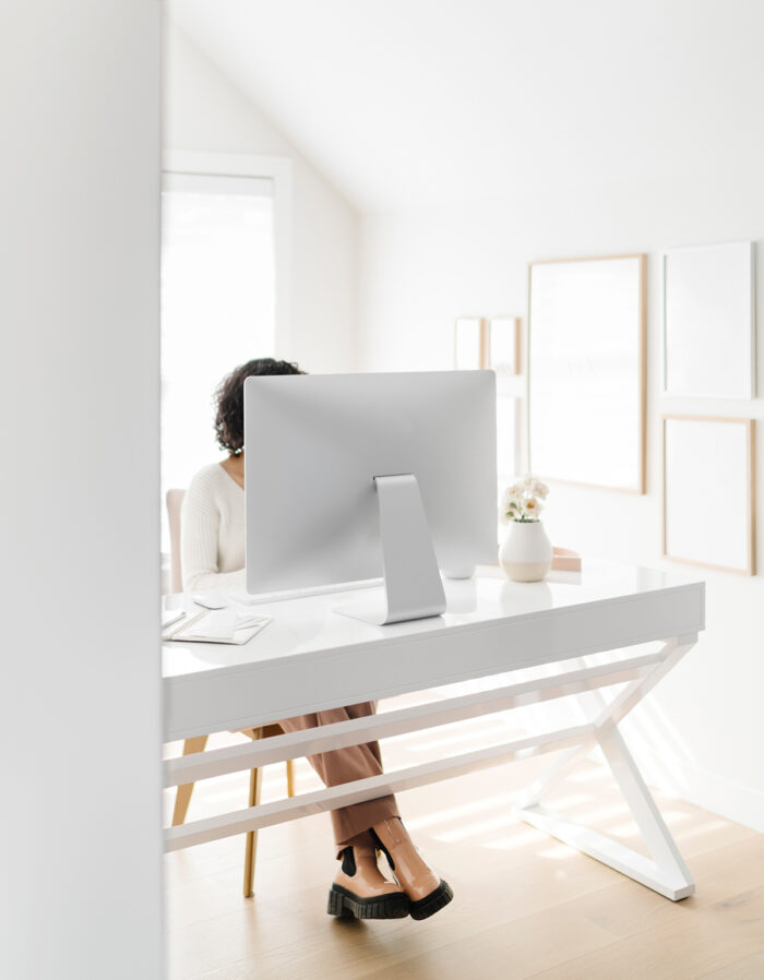 Woman working at a desk with a computer